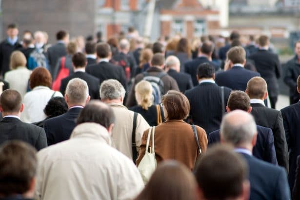 Office workers walking across London Bridge