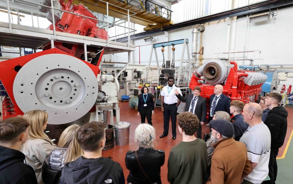 Group of people talking in ship factory