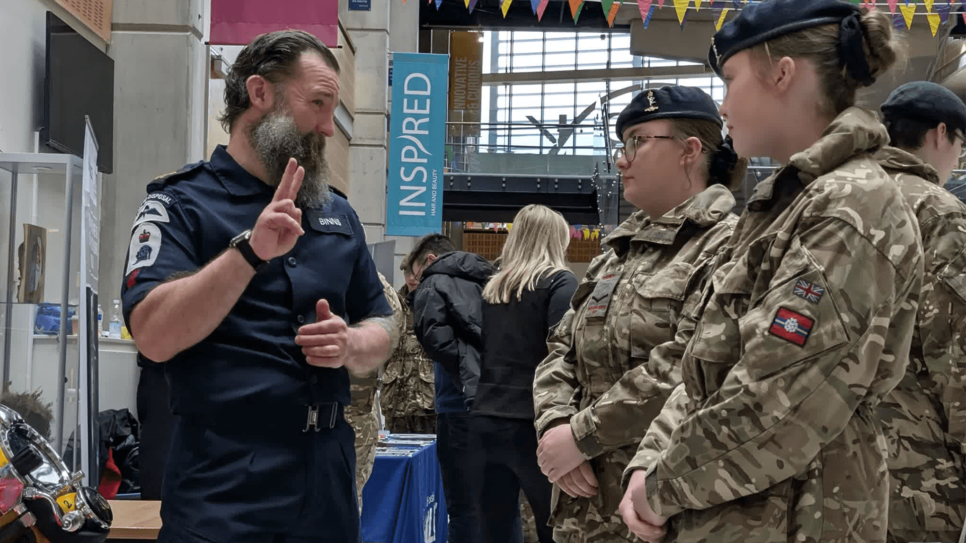 Service personnel talk through career options with cadets considering life after school