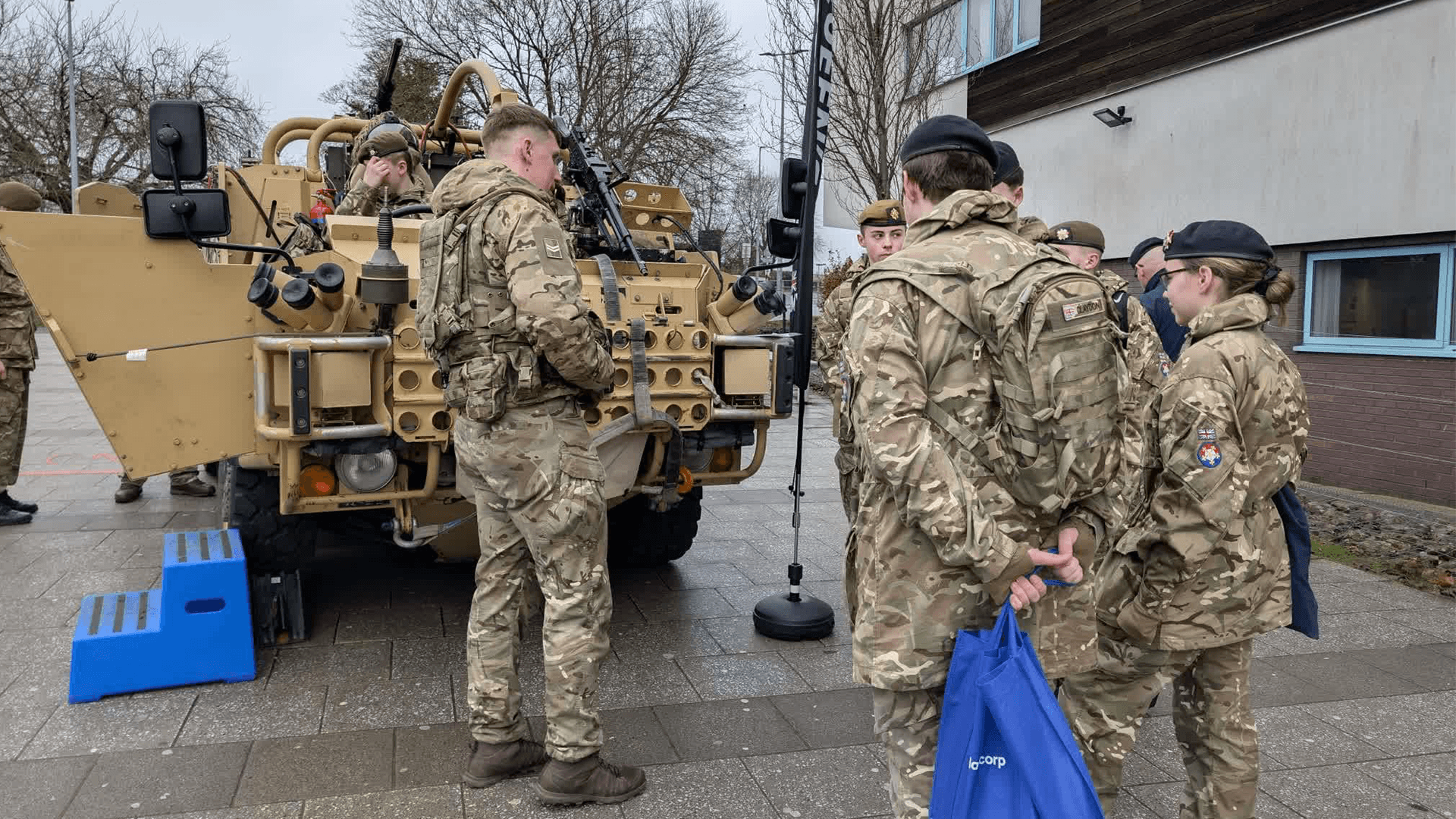 Cadets gather around a military vehicle display